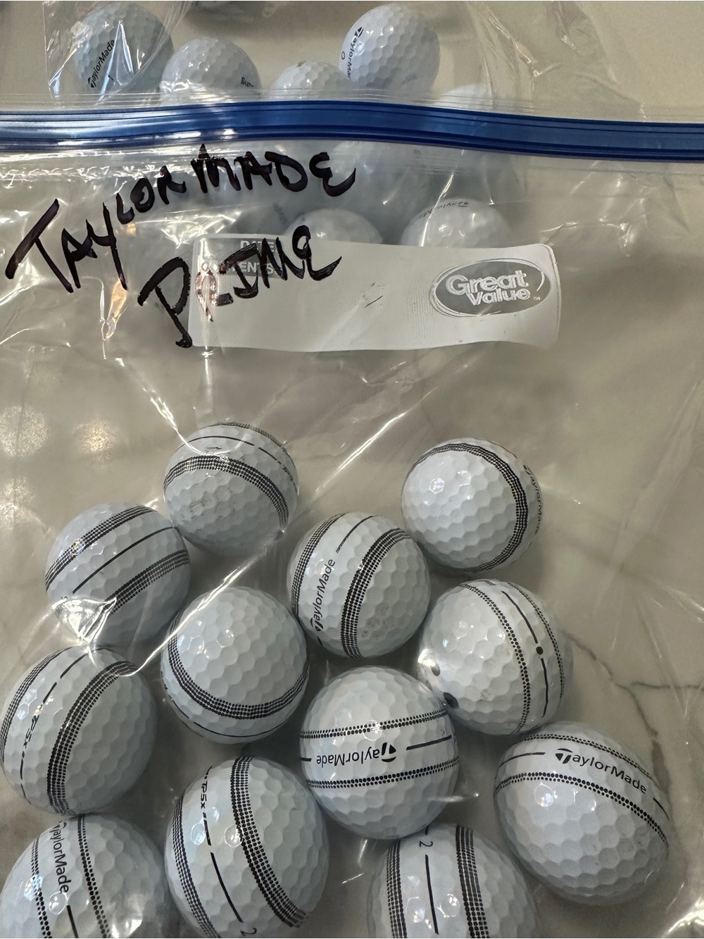 24 White-Black TaylorMade golf ball excellent condition.